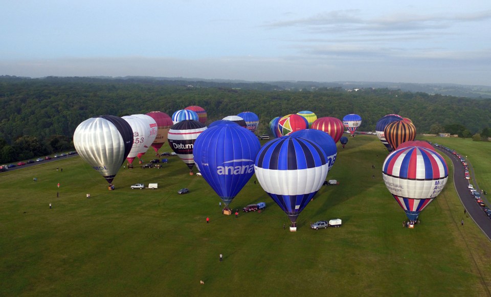 The inflated balloons gathered on the ground ahead of their spectacular launch at dawn today 