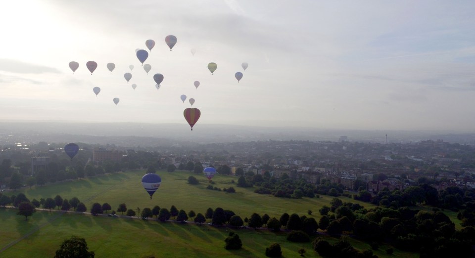 Balloons ascend in to the sky on the press launch for the 2016 Bristol Balloon Fiesta at Ashton Court Estate