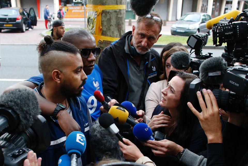 Relatives of victims (L) speak with jour