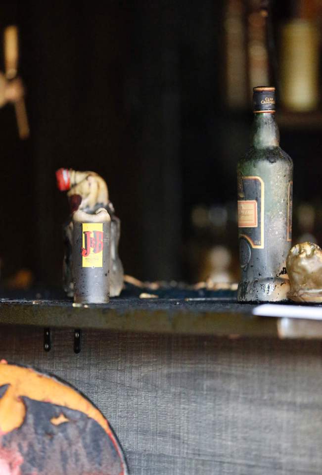 Damaged bottles and glasses are seen ins
