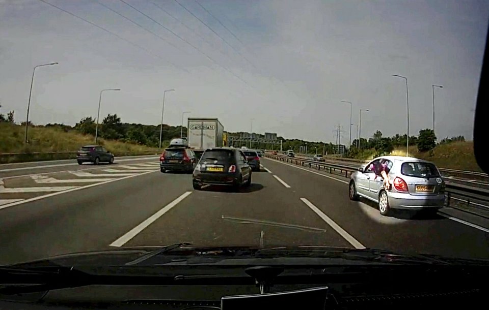 The man appears to be trying to put the cap back on the vehicle's petrol tank 