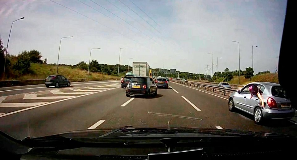 The Passenger can be seen to the right of the shot, hanging out of the car window