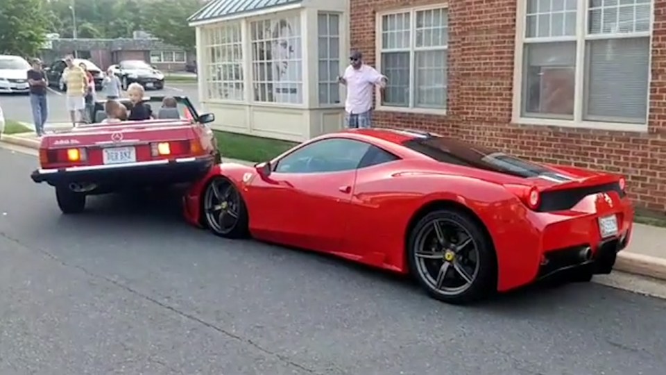 The car's furious owner emerges from a nearby coffee shop to see his pride and joy has been damaged by the clumsy motorist