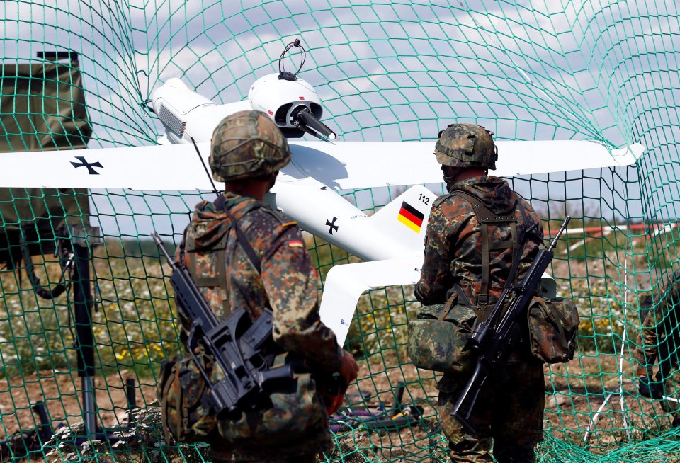 German soldiers remove a Luna drone from a net after its landing at the 13th reconnaissance battalion in Gotha