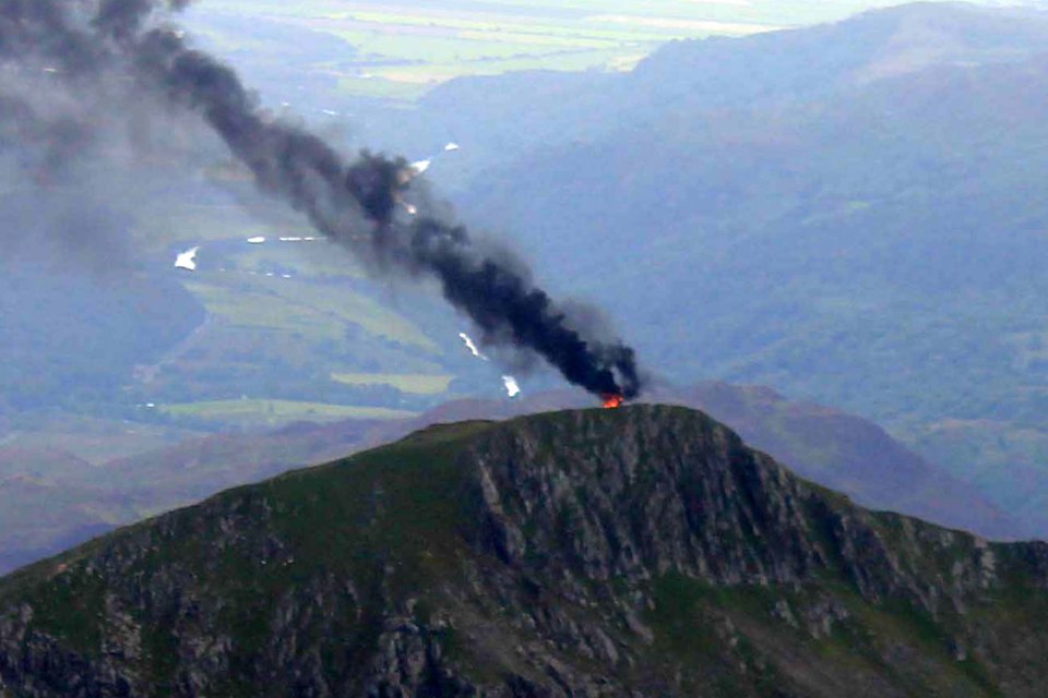 Huge pall of black smoke rises from a peak near Mount Snowdon after an RAF helicopter crashed today