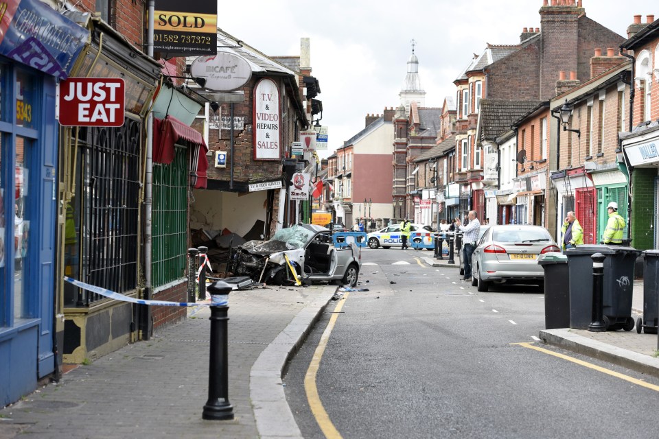 Police deployed a helicopter to search for a suspected third passenger after the car ploughed into an electronics shop