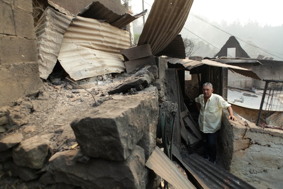 Local resident Avelino Viveiros returned to inspect the smouldering remains of his home in Curral dos Romeiros, Madeira