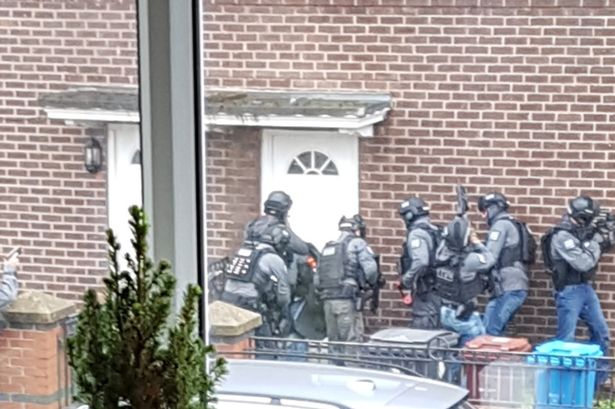  Heavily-armed cops prepare to raid home in Manchester following string of shootings that have rocked the city
