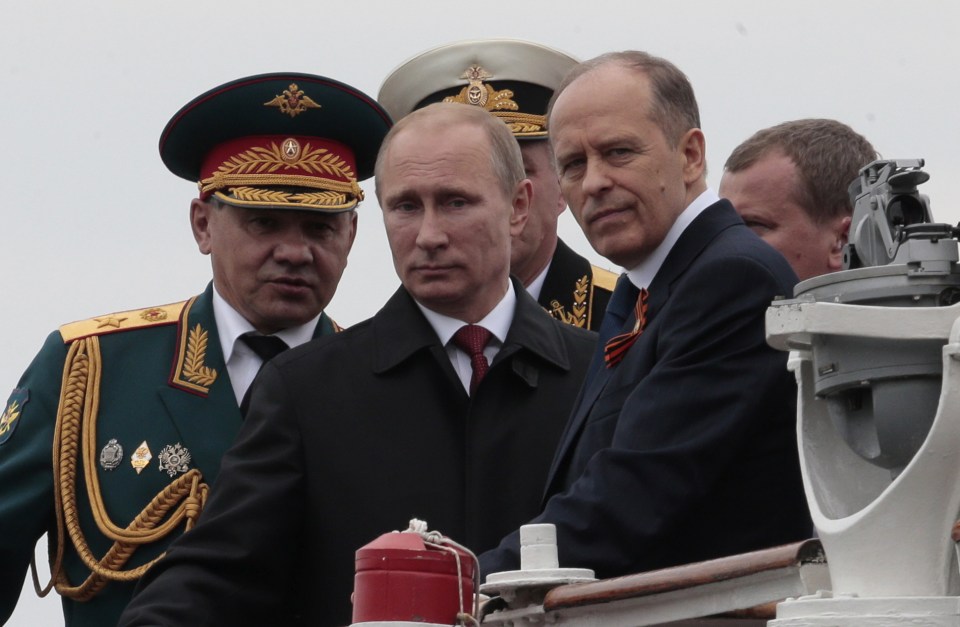 President Vladimir Putin is flanked by his security chiefs