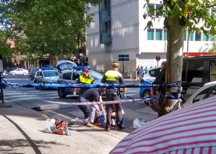 Medics race to treat a man following a shooting outside a shopping centre in the city of Zaragoza
