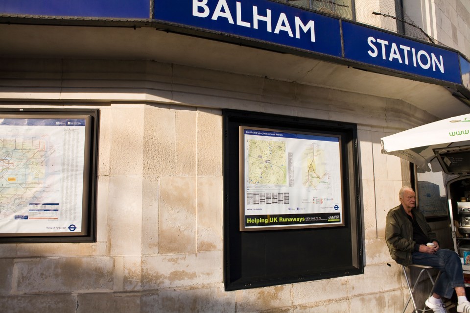 news vendor outside Balham station in sunshine
