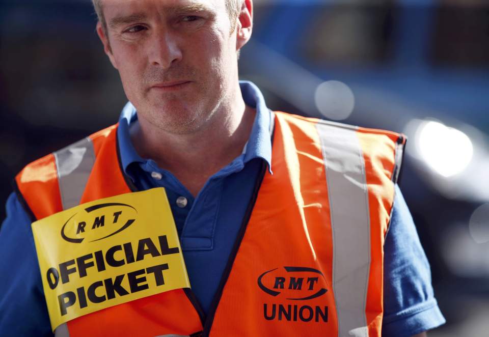 A striking member of the RMT union on the picket line at St. Pancras train station earlier this week 
