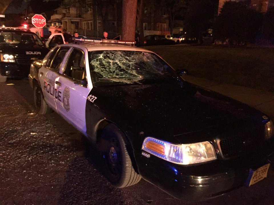 A police car with broken windows is seen in a photograph released by the Milwaukee Police Department after disturbances following the police shooting of a man in Milwaukee