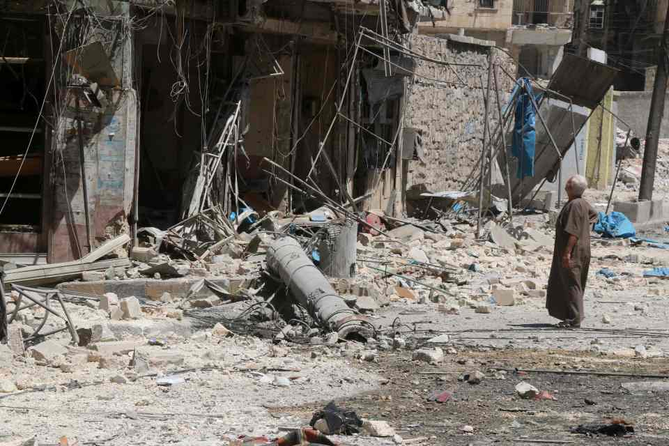 A resident of the Tariq al-Bab neighbourhood of Aleppo, inspects the damage caused by reported air raids