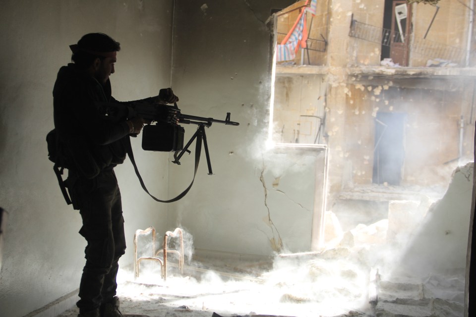 A Free Syria Army member seen fighting in the heavy battle in Aleppo neighbourhood of Sheikh Maksoud