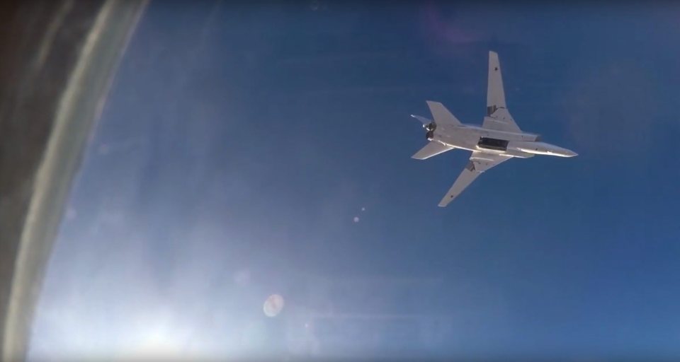 An image from Russian Defense Ministry video footage that was issued 16 August 2016, showing a Tu-22M3 long-range bomber in flight after releasing its payload above Syria