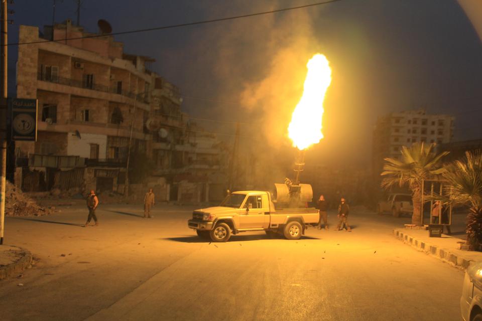 Free Syria Army fighters aiming at Russian fighter jets using anti-aircraft artillery