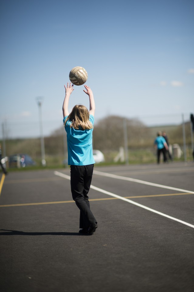 Pupils playing games at breaktime in a primary school, Wales UK