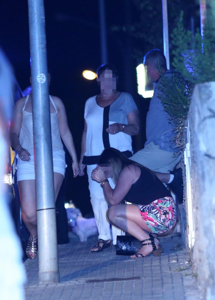 One woman sobs at the side of the street after the horrific killing last night. The shooting took place in front of the victim's family