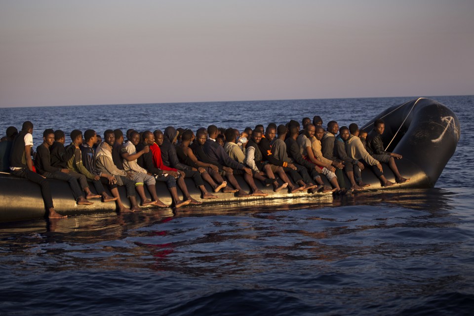 Migrants, mostly from Nigeria, crowd onto a dinghy as they sail fleeing Libya