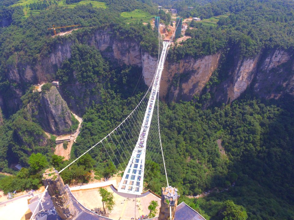 People visit a glass bridge at a gorge as it opens to public in Zhangjiajie