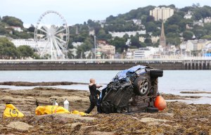 Man dies after crashing his car through metal railings and plummeting 50ft to rocks below