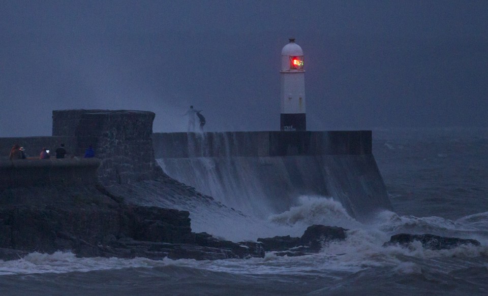 Teenagers risk their lives playing chicken with huge waves.