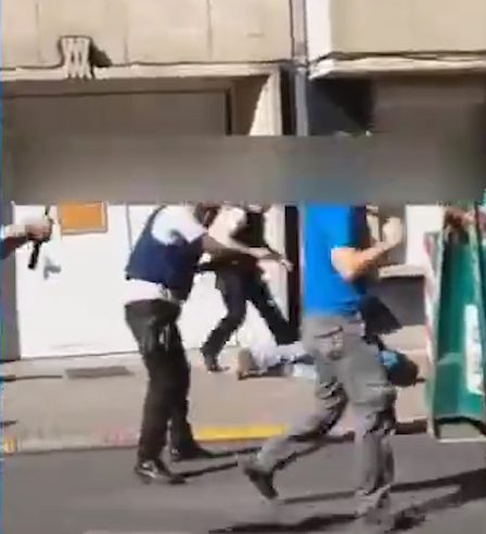 Crowds then scurry away as police surround the suspect on the ground