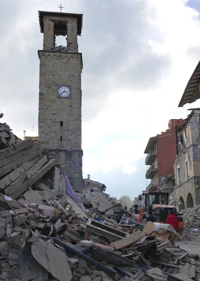 The clocktower in Amatrice remains standing amidst the devastation. The time reflects to moment the quake struck