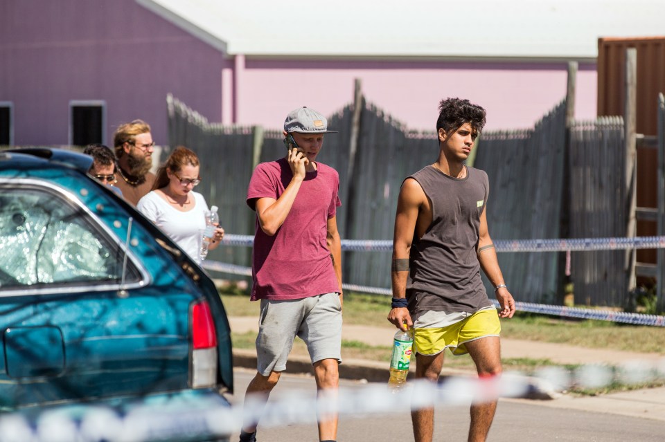 A group of backpackers are escorted from the crime scene following the horrendous attack