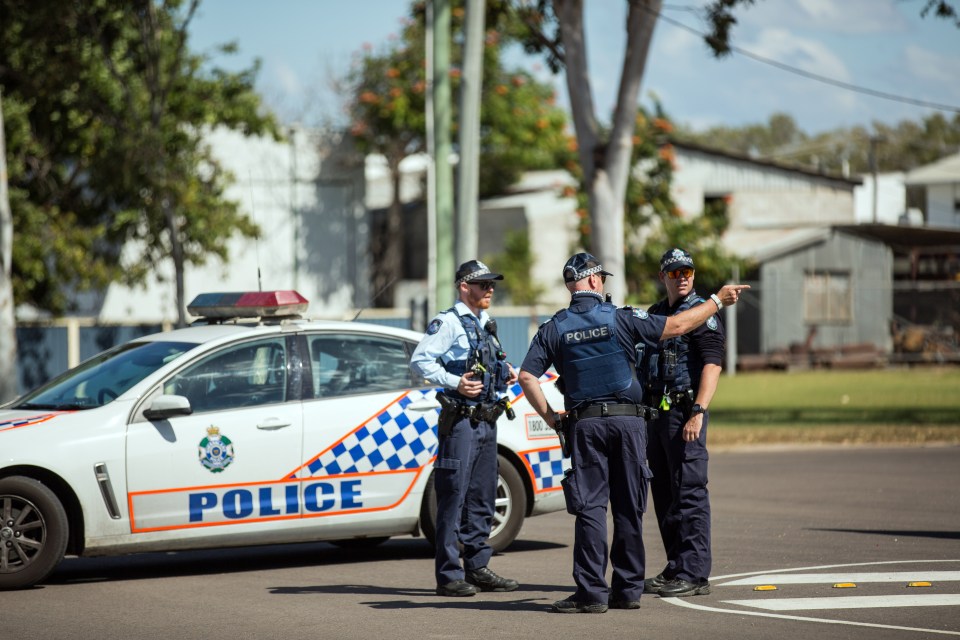 Cops today stand guard at the scene of the attack 