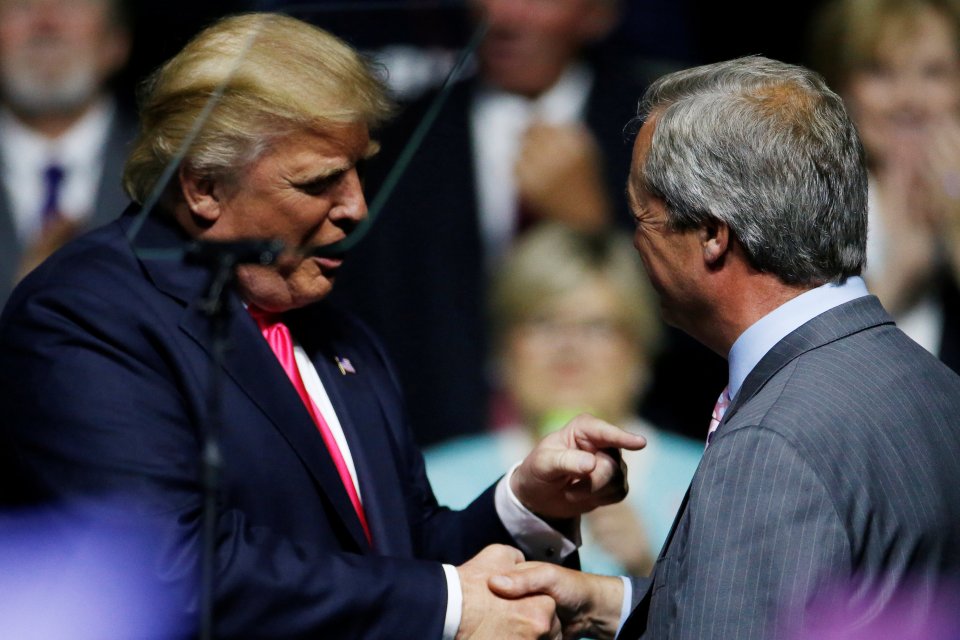 Republican presidential nominee Donald Trump shakes hands with Member of the European Parliament Nigel Farage at a campaign rally in Jackson