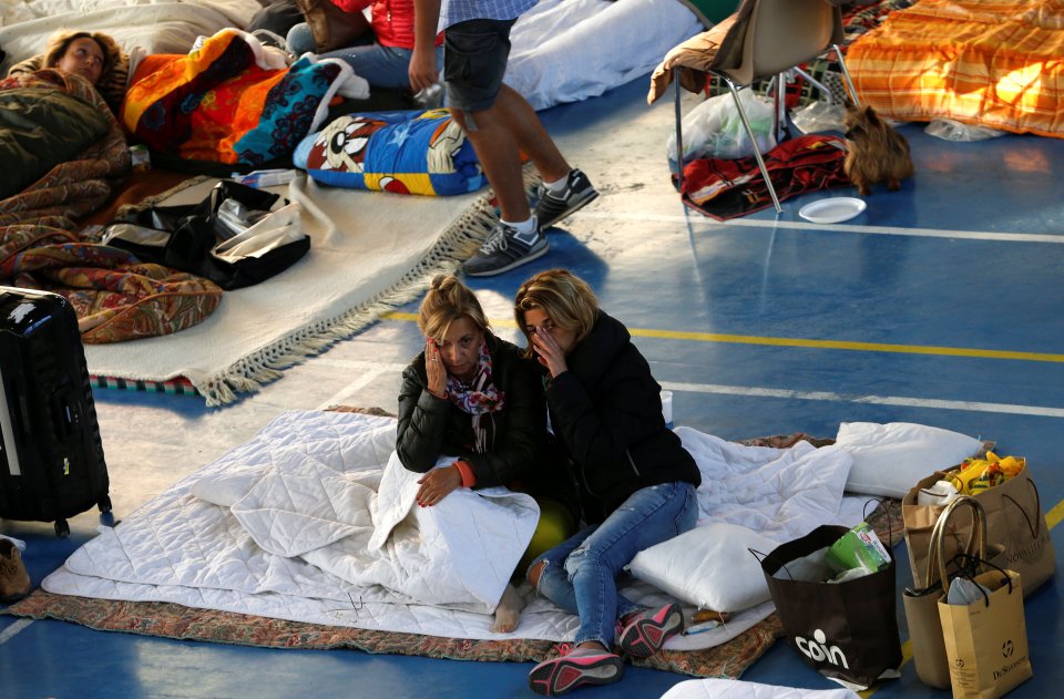People rest following an earthquake in Amatrice