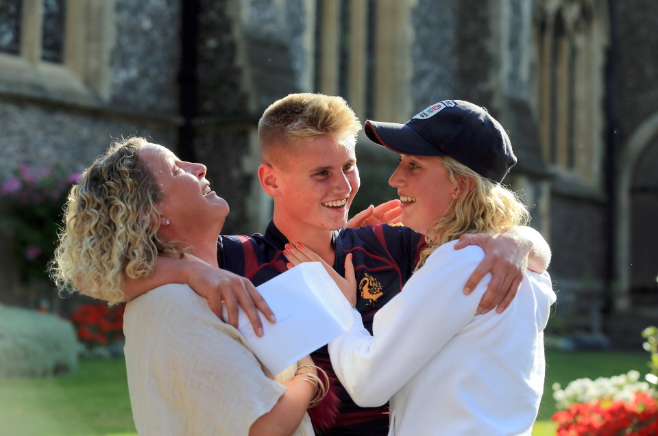 Jay Parvin celebrates with mum Jane (left) and sister Phoebe after he received his GCSE results at Brighton College in Brighton, East Sussex