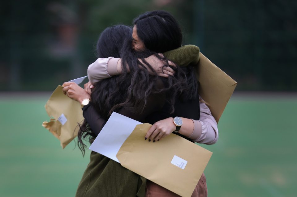 Pupils at Withington Girls' School react as they open their GCSE exam results as 72% of pupils taking GCSE exams achieved A* grades and 95.5% attaining A* to A
