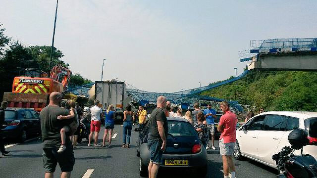 Stunned on-lookers stare at the scene which looks like something from a disaster movie