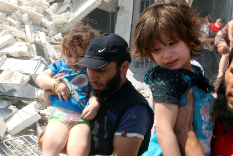 Distressed girls are evacuated from site after pro-Assad choppers attacked with indiscriminate barrel bombs