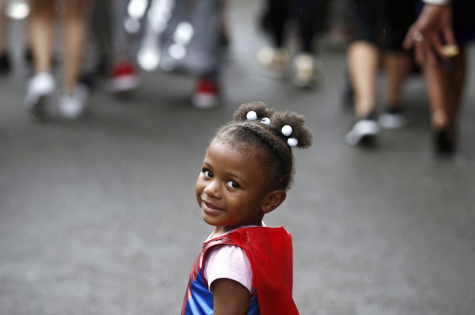 An adorable performer participates in the children's day parade 