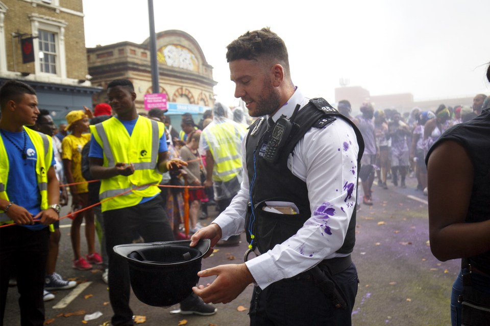 Another copper is smothered in paint during the festivities
