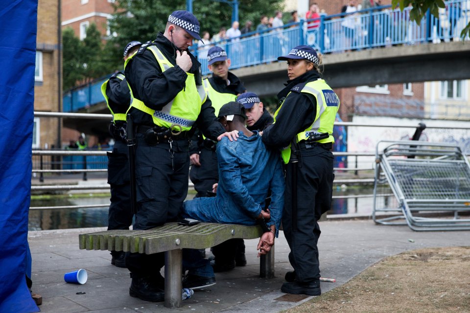 A man is placed in handcuffs by police