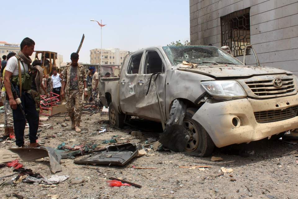 Yemenis, including soldiers, inspect deb