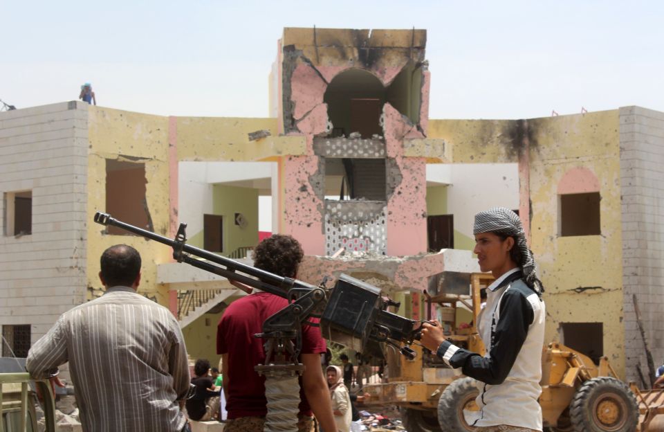 Yemeni security forces stand guard with
