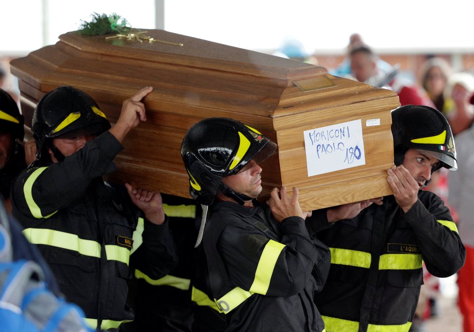 Much of the rescue effort has been carried out by fire crews. Several firefighters are seen here carrying a casket at the service