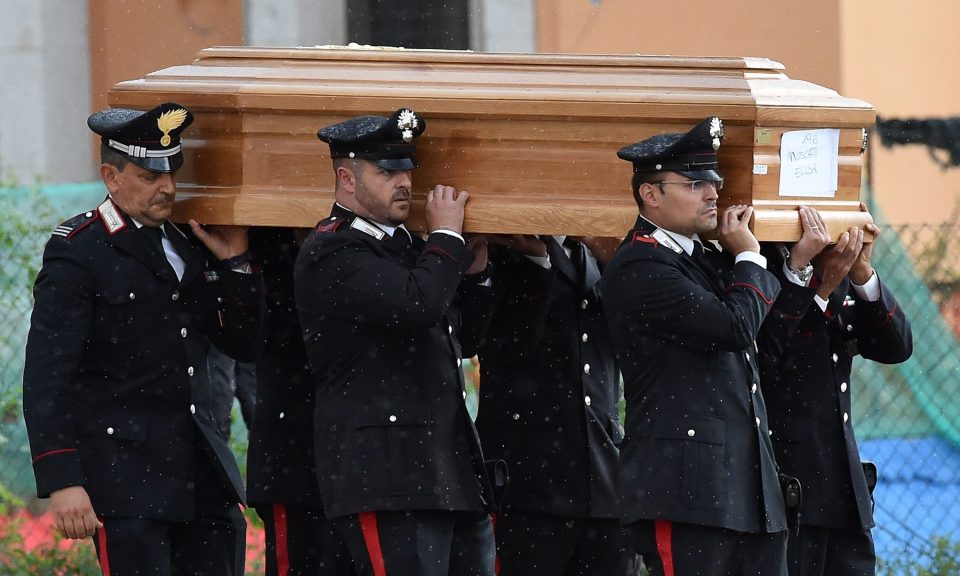 Many of the caskets were carried by the emergency teams who have battled this week to free the bodies of the dead