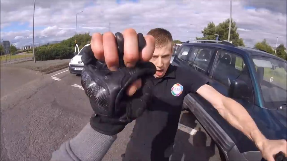 The man shouts 'Come on then' and the pair begin to grapple