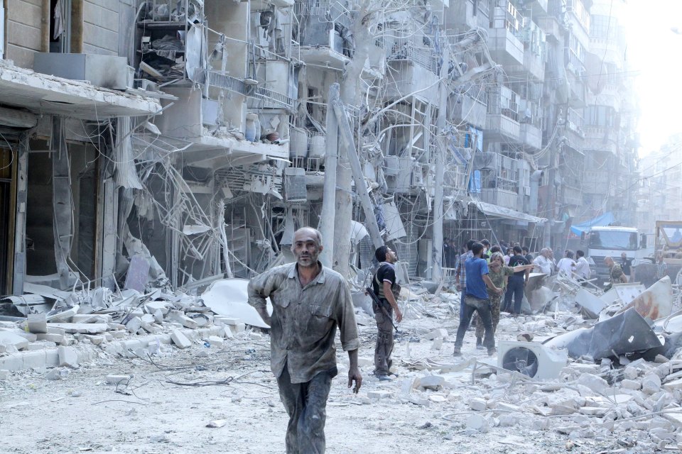 Residents look for survivors in a damaged site after what activists said was a barrel bomb dropped by forces loyal to Syria's president Bashar Al-Assad in Al-Shaar neighbourhood of Aleppo, Syria