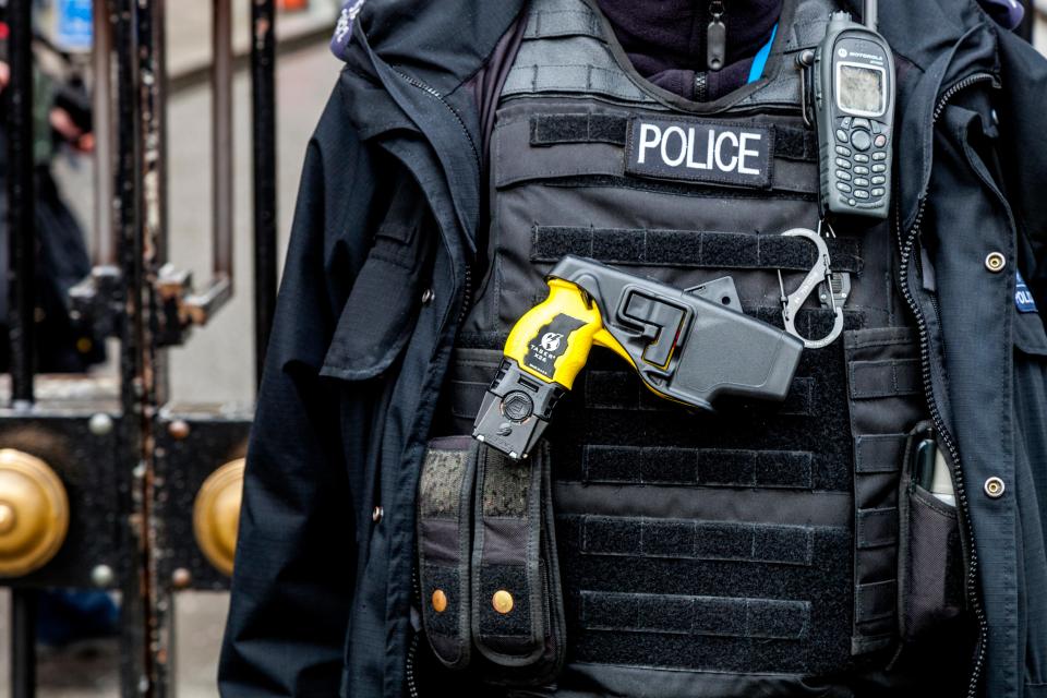 British Police Officer With Taser Gun