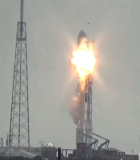 An explosion rocks the giant rocket as it sits ready for lift off