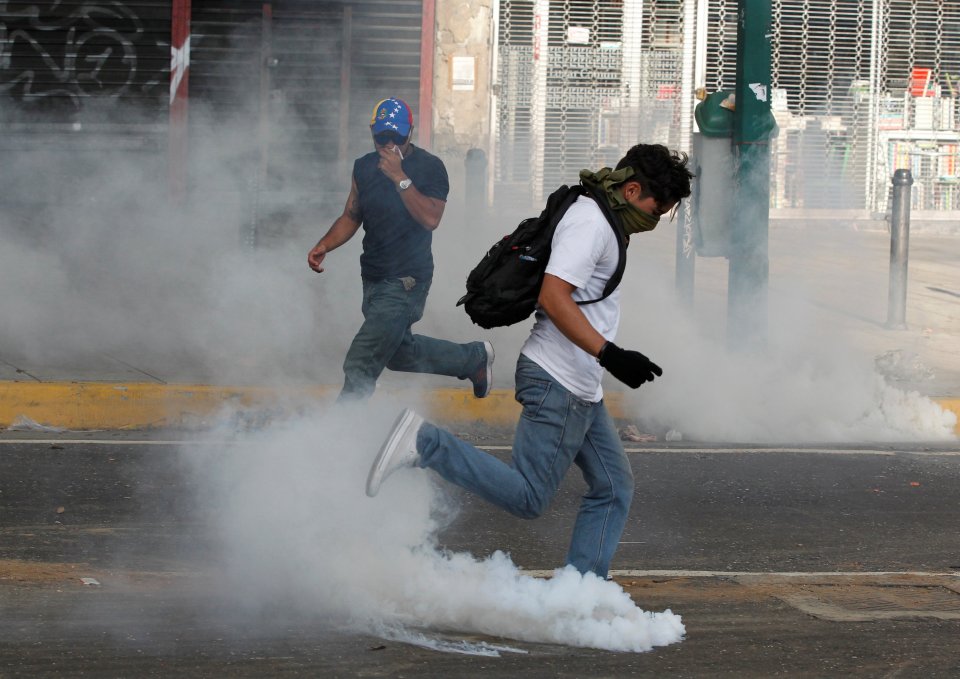 Protesters clash with police during a rally to demand for a referendum to remove Venezuela's President Maduro in Caracas