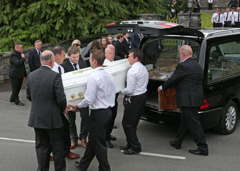 amily members grieve as one of the boys of the Hawe family is carried into the church